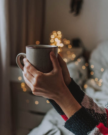 Hands holding coffee cup