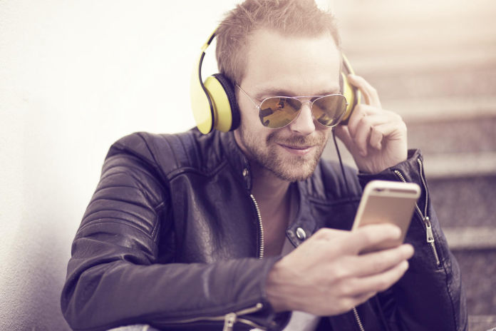 Man listening to headphones with phone